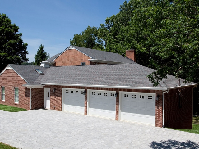outside brick home with 3 car garage